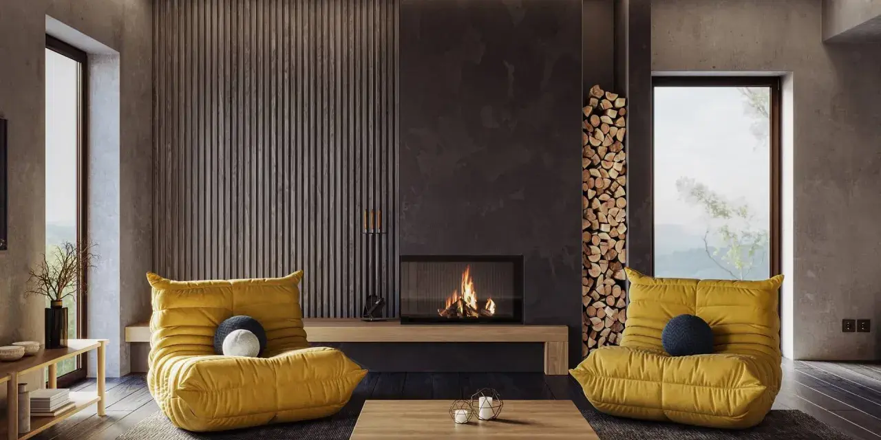 Gemütliches Wohnzimmer mit gelben Sesseln und Kamin. Die **Farben und ihre Wirkung** sind hier harmonisch auf die Einrichtung abgestimmt.
