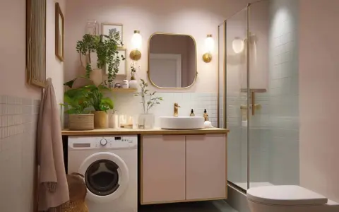 Schickes kleines Badezimmer mit Waschmaschine, Dusche und Waschbecken. Tolle Tipps zum kleines Badezimmer dekorieren mit Pflanzen und goldenen Akzenten.