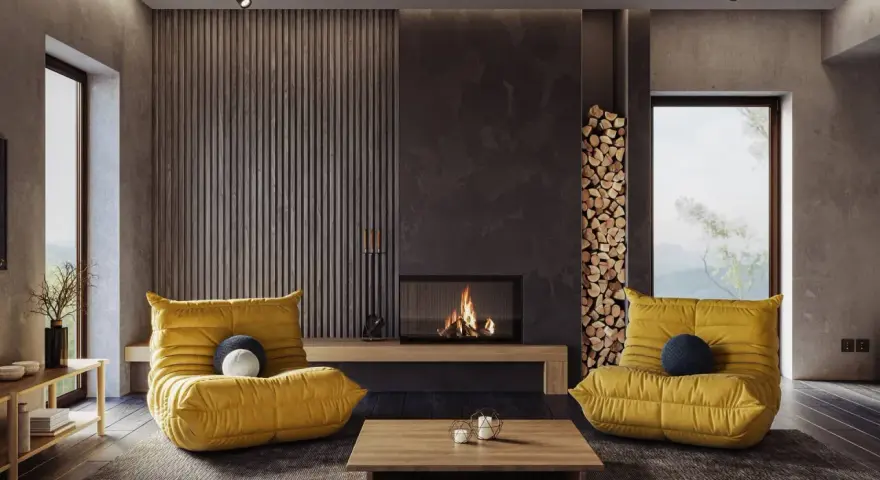 Gemütliches Wohnzimmer mit gelben Sesseln und Kamin. Die **Farben und ihre Wirkung** sind hier harmonisch auf die Einrichtung abgestimmt.