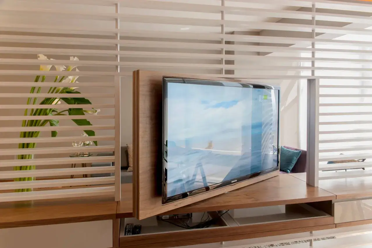 Ein moderner Einbauschrank mit integriertem drehbarem TV, der sich perfekt ins Schlafzimmer integrieren l&auml;sst. Wei&szlig;e Lamellen verbergen den Blick auf den Fernseher, wenn er nicht gebraucht wird.
